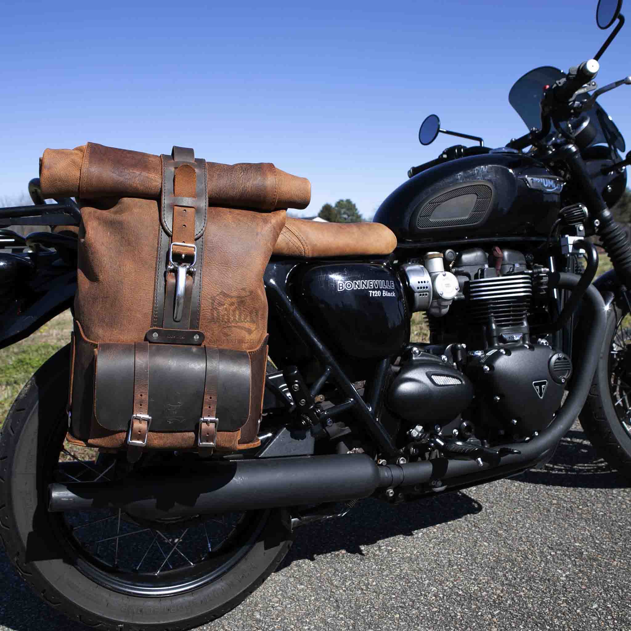 Upgrade your ride with the URB01 Rolltop Backpack Saddlebag. Unique design enables quick conversion from saddlebag to backpack. Hand crafted in USA with premium veg tan water buffalo leather and stainless steel hardware. Durable and stylish, it's the perfect fit for your motorcycle.