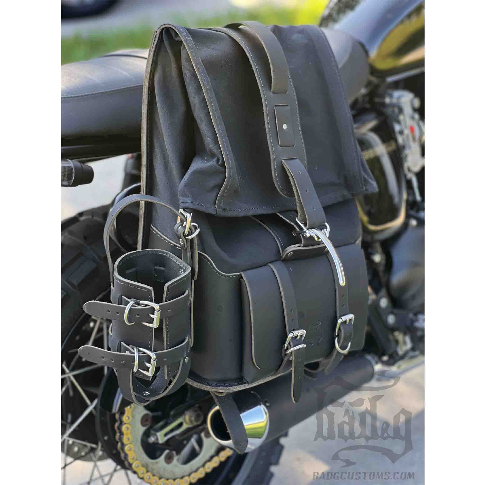 Upgrade your ride with the URB03 Rolltop Backpack Saddlebag. Unique design enables quick conversion from saddlebag to backpack. Hand crafted in USA with premium veg tan water buffalo leather, waxed canvas and stainless steel hardware. Durable and stylish, it's the perfect fit for your motorcycle.